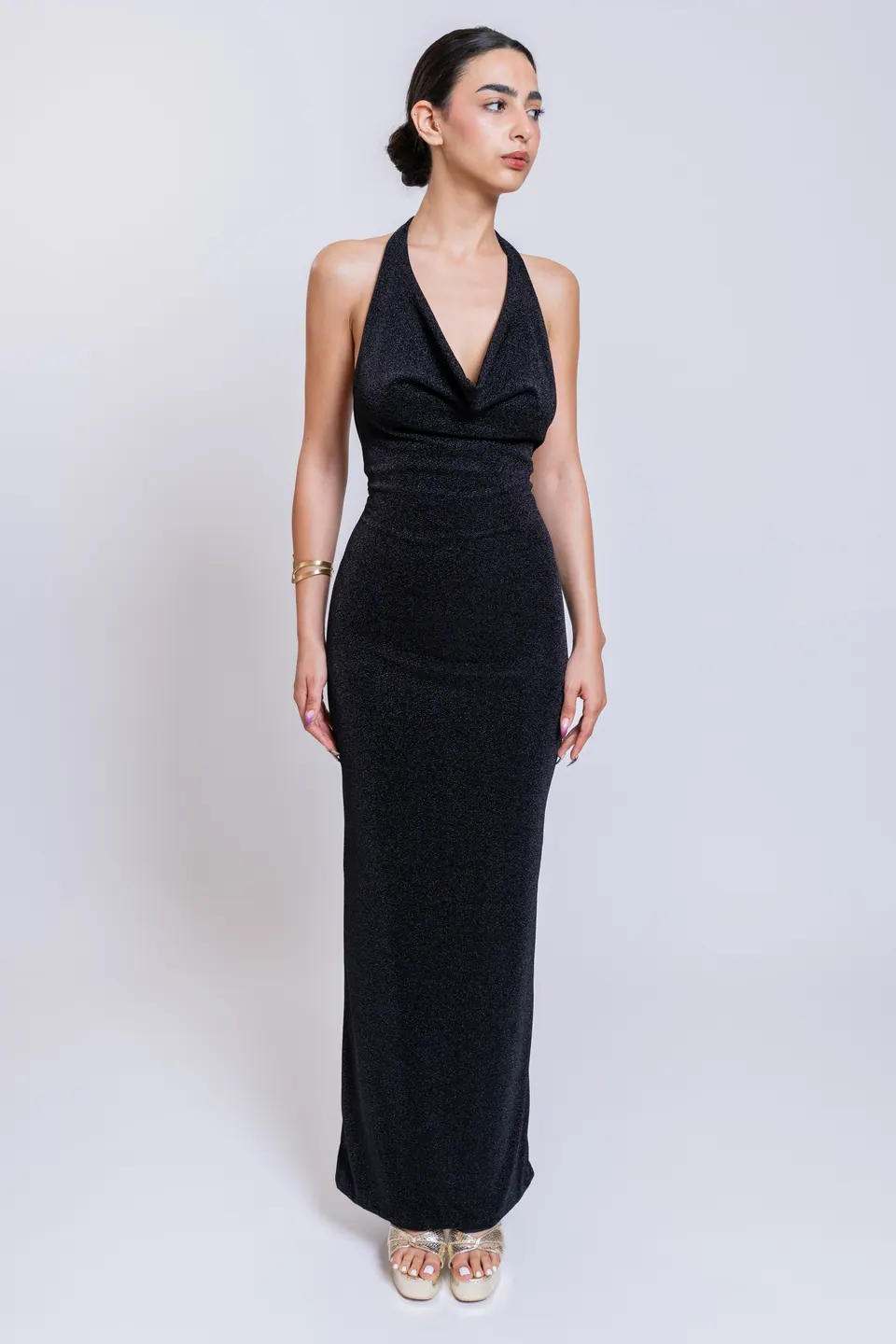 Model wearing the GALIA black draped cowl halter neck maxi dress, front view