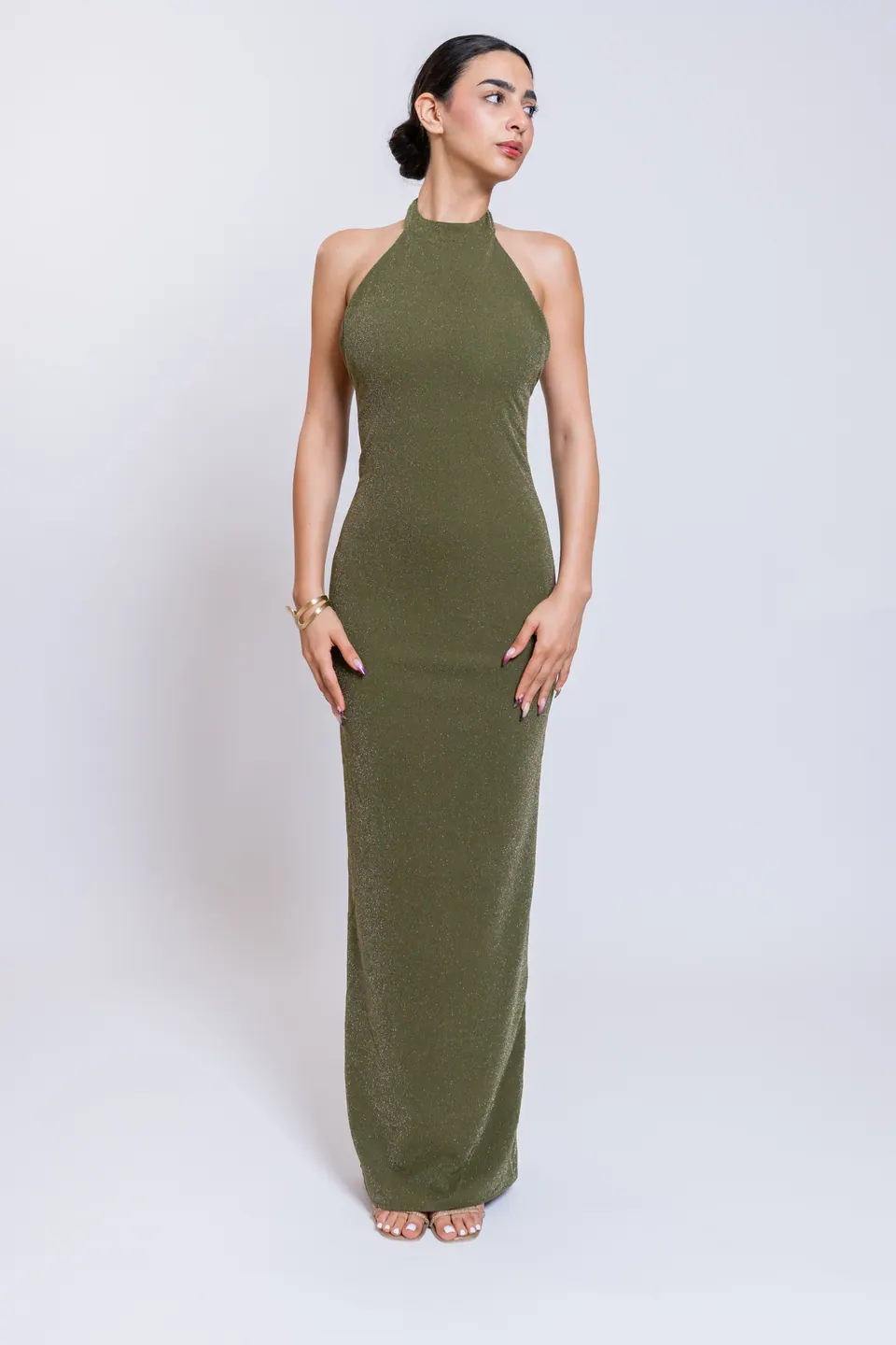 Model wearing the CÉLINE olive green high halter neckline maxi dress, front view