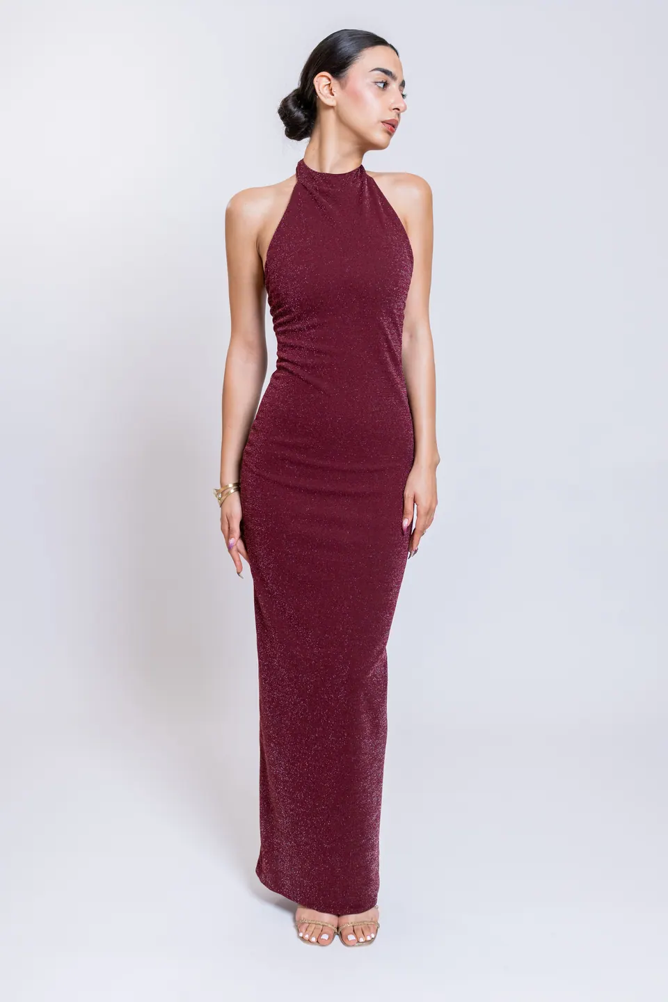 Model wearing the CÉLINE burgundy high halter neckline maxi dress, front view